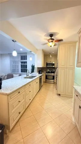 a kitchen with stainless steel appliances granite countertop a sink and a stove