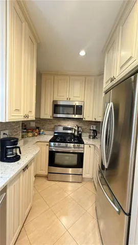 a kitchen with refrigerator a microwave and cabinets