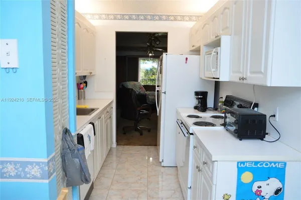 a kitchen with a refrigerator and a stove