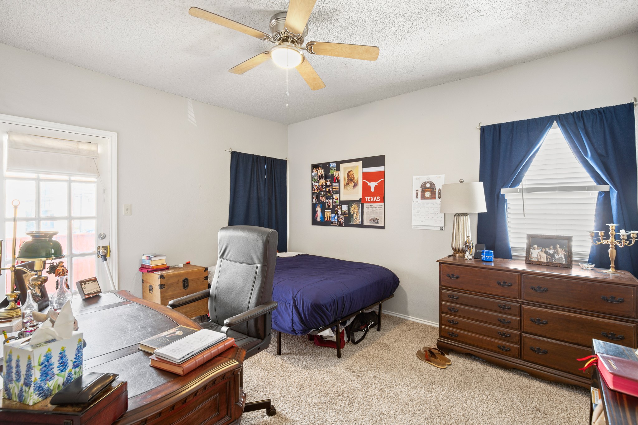 706 West 22nd Street, Unit 206 Austin, TX 78705 - Photo 8 of 18 Bedroom with multiple windows, light carpet, ceiling fan, a textured ceiling, and a desk
