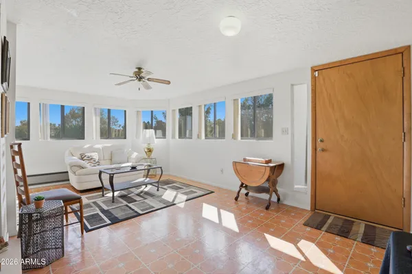 a living room with furniture a window and a table
