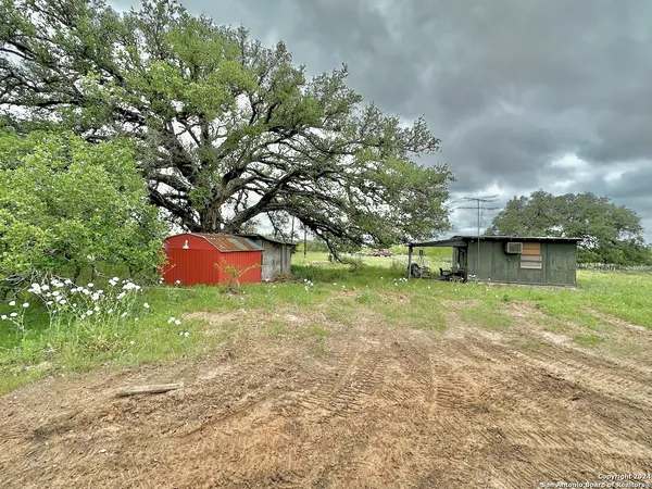 a backyard of a house with lots of green space and garden