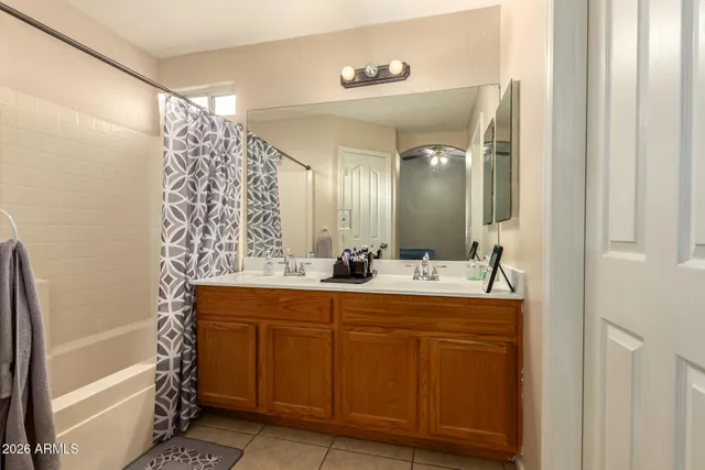 a bathroom with a double vanity sink mirror and shower