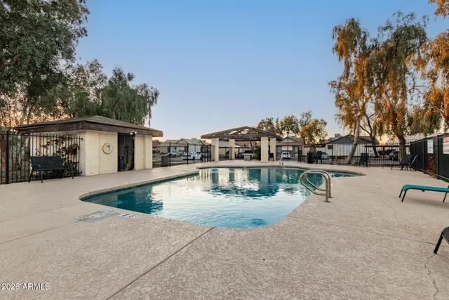 a view of a house with swimming pool and sitting area