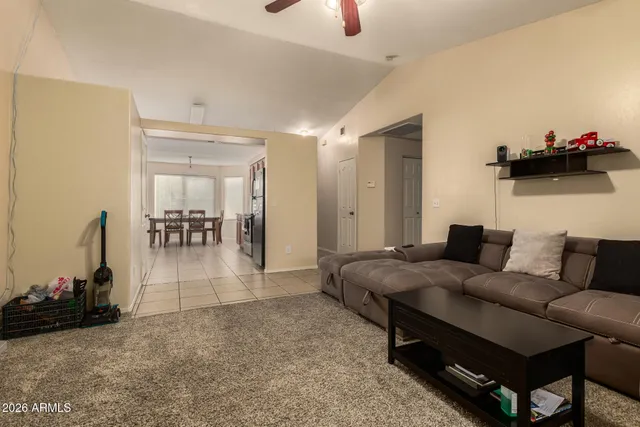 a living room with furniture and a dining table with kitchen view