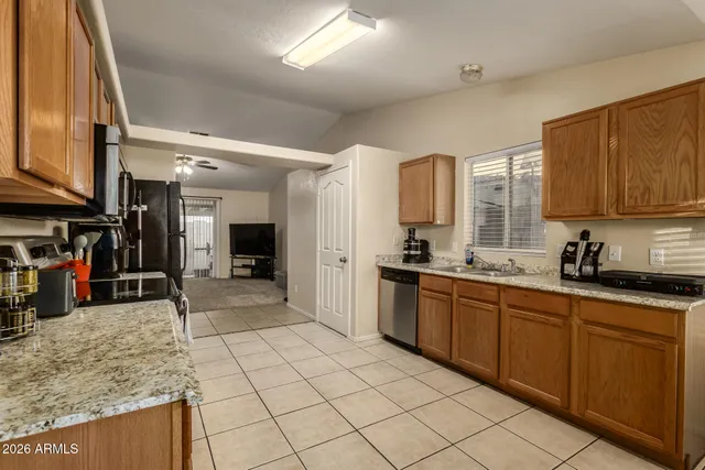 a kitchen with stainless steel appliances granite countertop a sink and cabinets