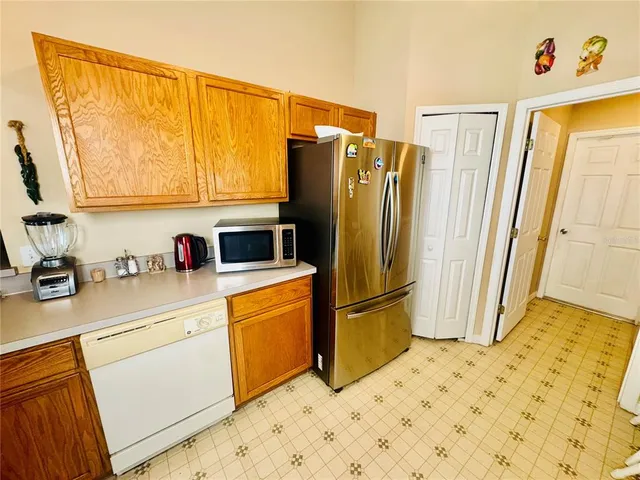 a kitchen with a refrigerator and a sink