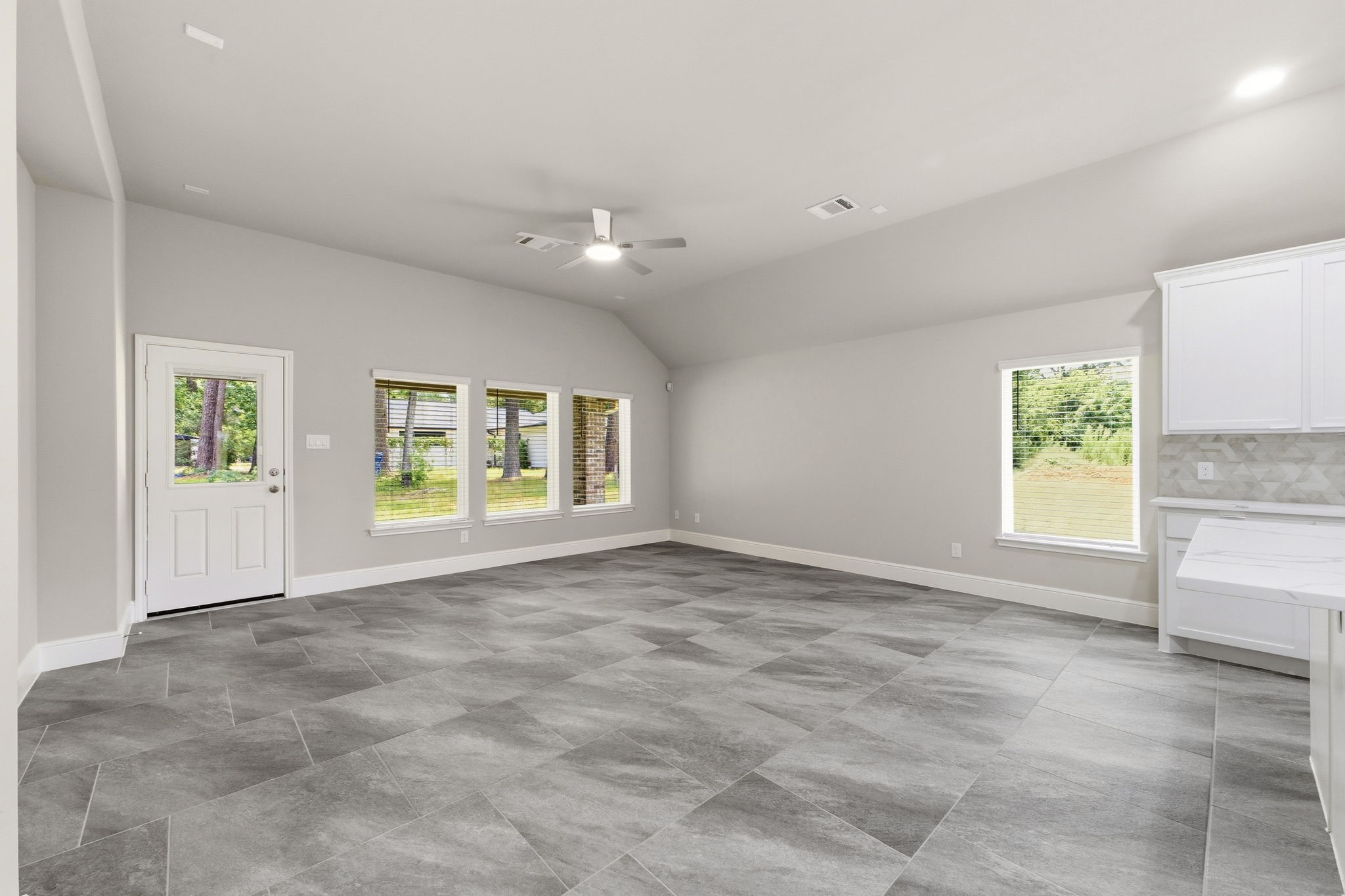 23620 Youpon Lane Spring, TX 77389 - Photo 16 of 37 Light filled living room with expansive windows, seamlessly open to the kitchen and dining area.