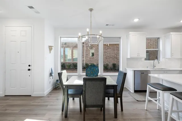 a kitchen with cabinets appliances a sink and a counter top