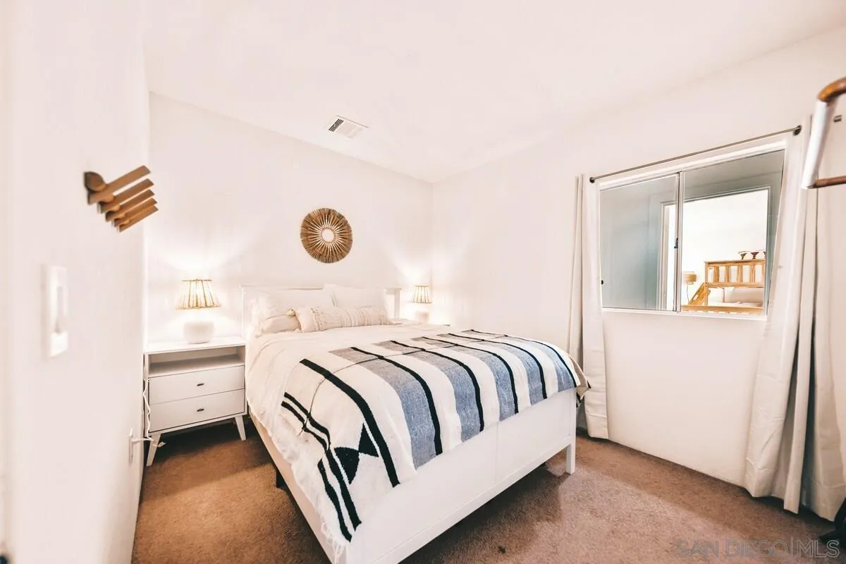 3900 Ave Tortuga Joshua Tree, CA 92252 - Photo 7 of 28 a bedroom with a bed and window
