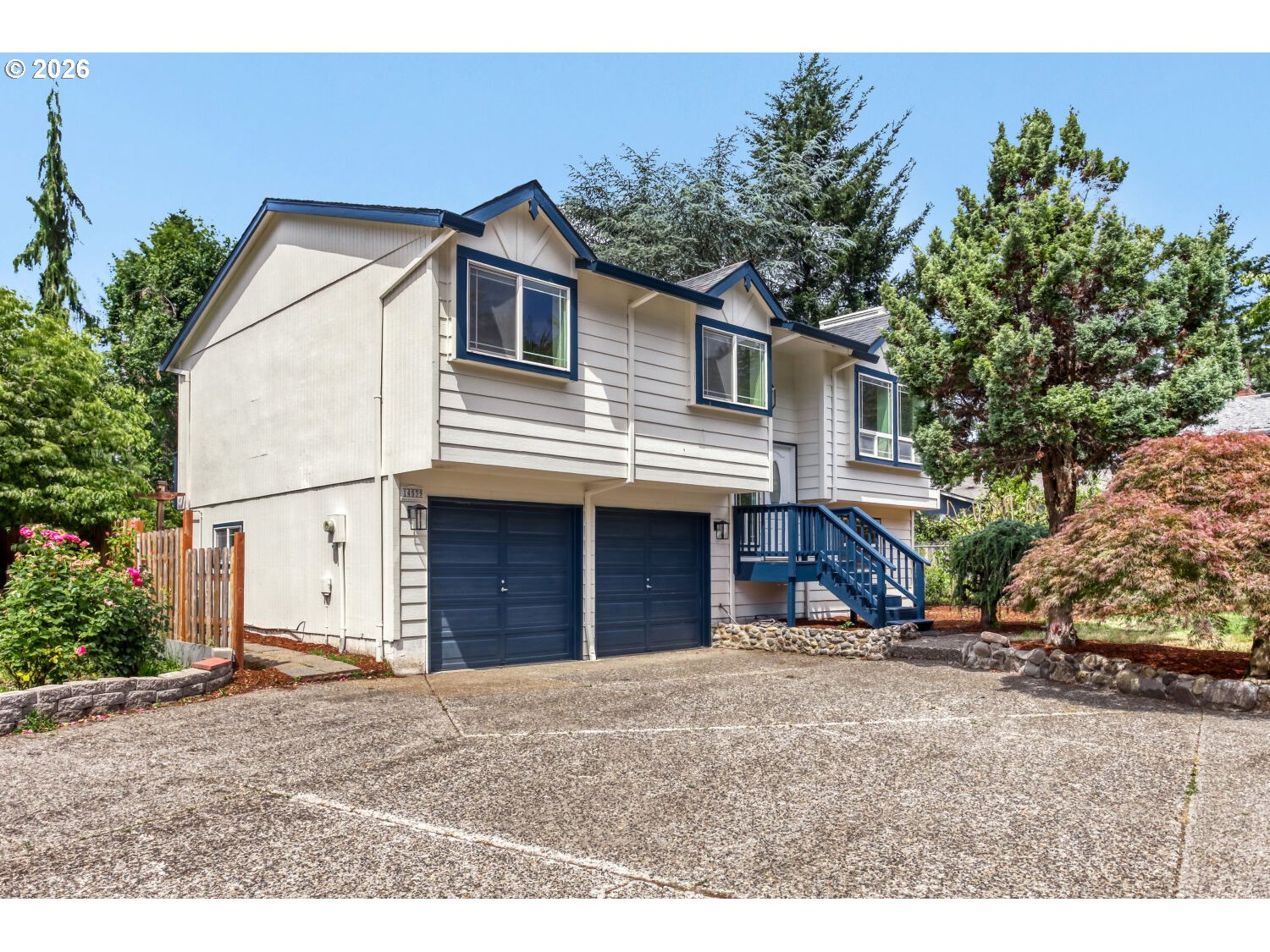 14539 Southeast Center Street Portland, OR 97236 - Photo 1 of 30 a view of a house with a backyard and garage