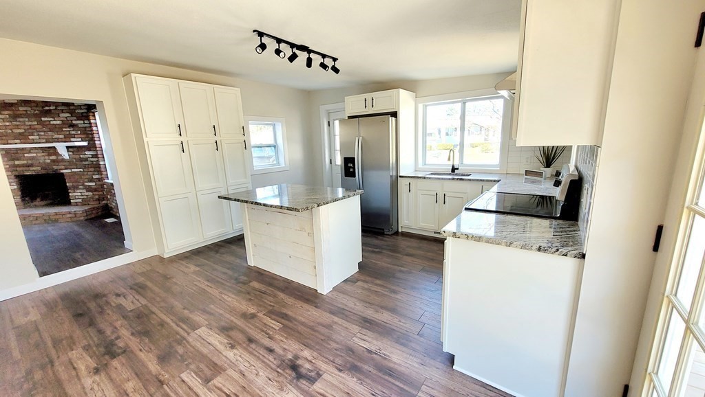 9 Belanger Road Southampton, MA 01073 - Photo 8 of 19 a kitchen with a counter top space a sink a refrigerator freezer a large window and wooden floor