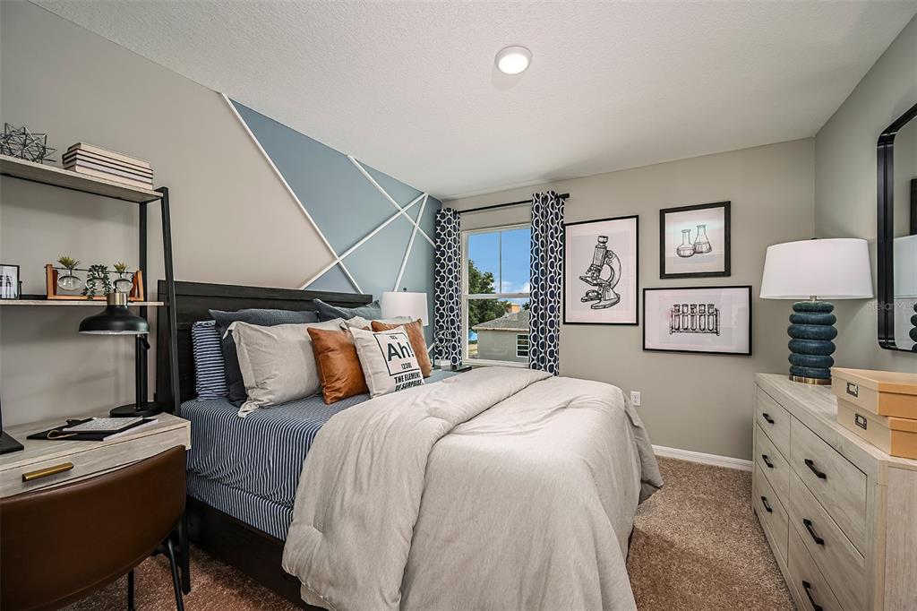 1334 Palmeroy Road Haines City, FL 33844 - Photo 18 of 22 a bedroom with a bed and a flat tv screen on the dresser