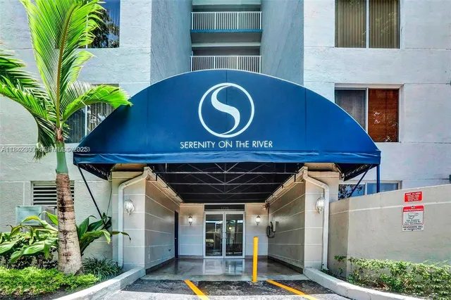 a front view of a house with plants