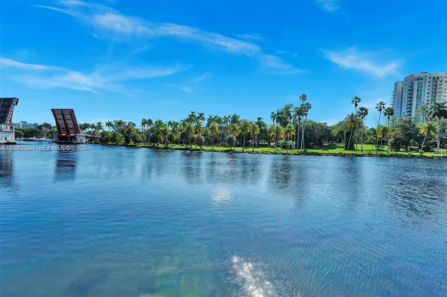 a view of a lake with houses in the back