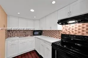 a kitchen with granite countertop a stove and a cabinets