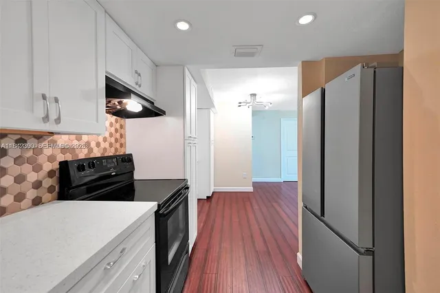 a kitchen with stainless steel appliances a refrigerator and a stove