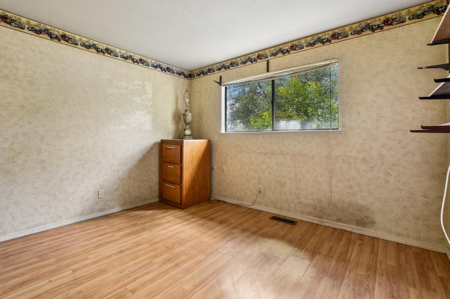 6180 Rustic Hills Drive Rocklin, CA 95677 - Photo 11 of 37 a view of an empty room with wooden floor and a window