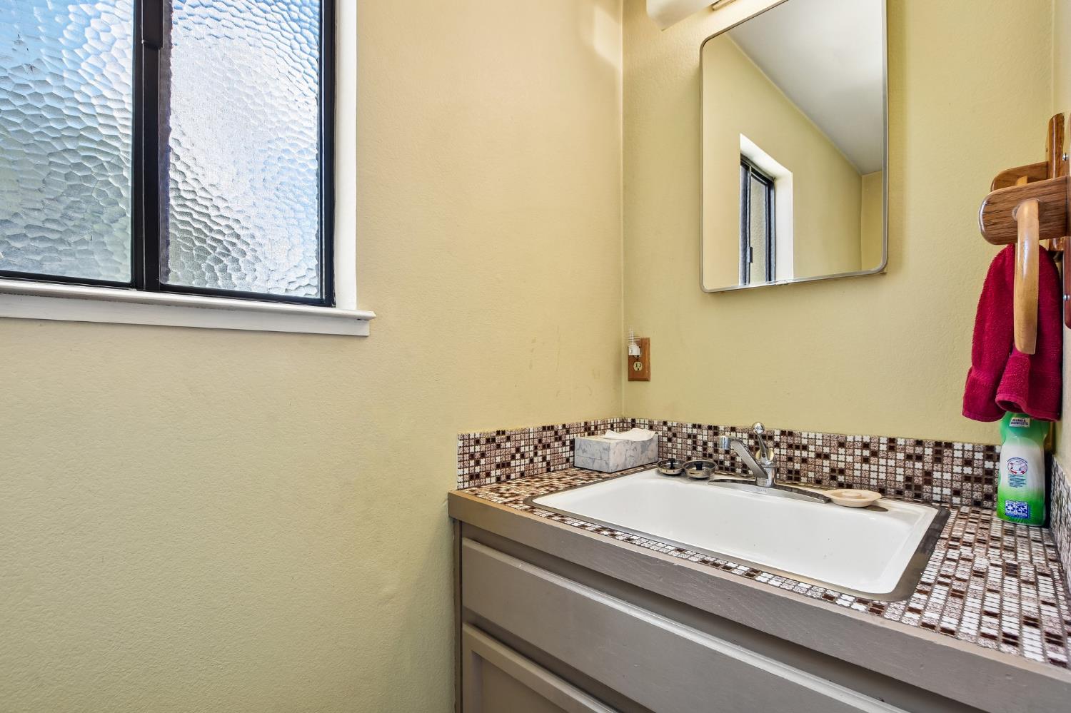 6180 Rustic Hills Drive Rocklin, CA 95677 - Photo 13 of 37 a bathroom with a granite countertop sink and a mirror