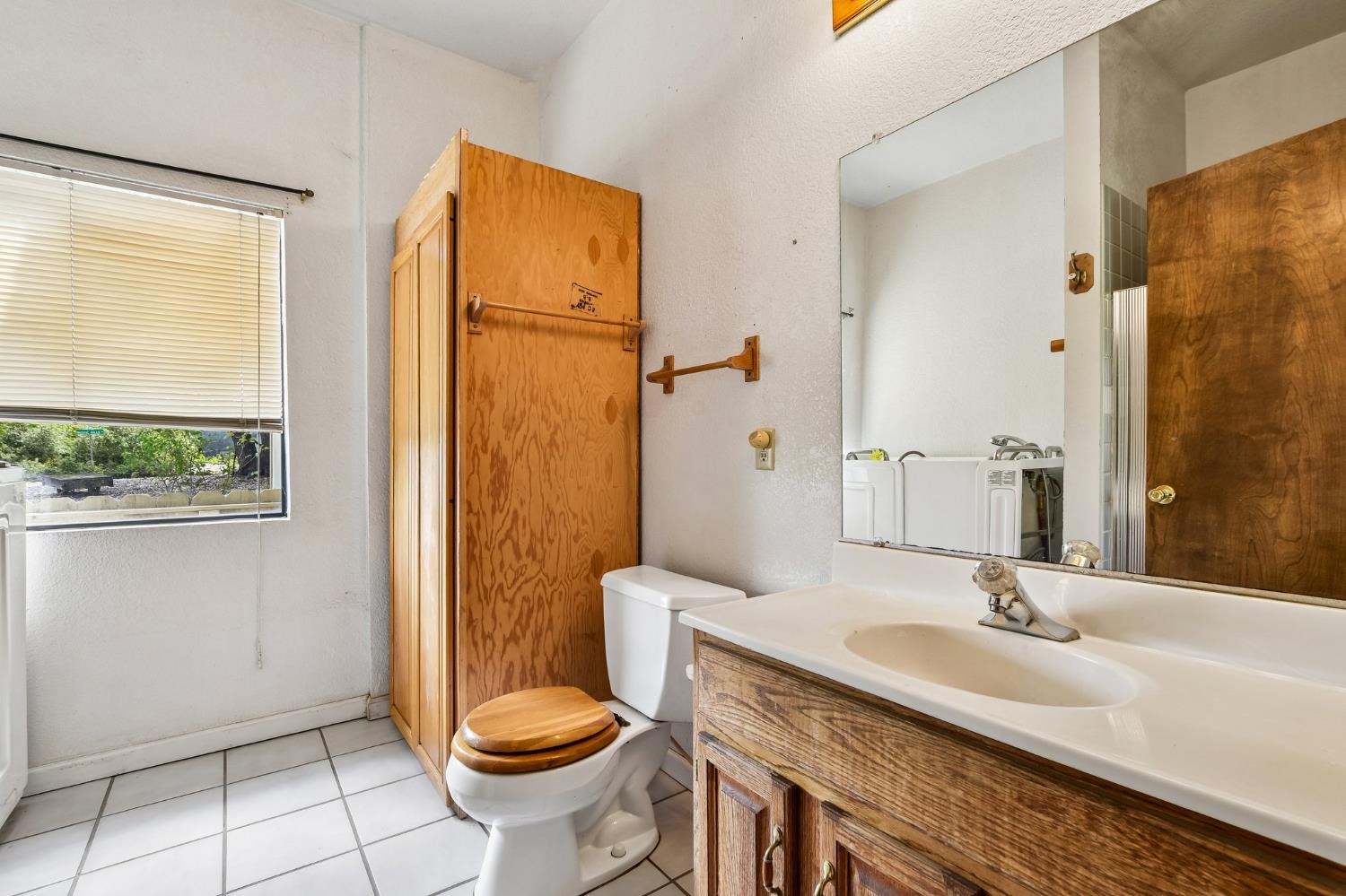 6180 Rustic Hills Drive Rocklin, CA 95677 - Photo 17 of 37 a bathroom with a granite countertop sink toilet and shower