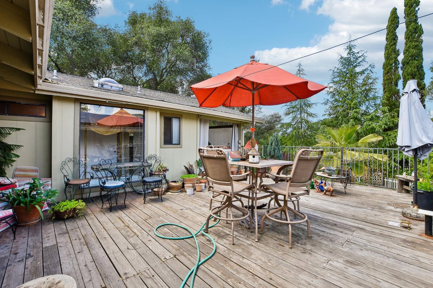6180 Rustic Hills Drive Rocklin, CA 95677 - Photo 32 of 37 an outdoor space with furniture and umbrella
