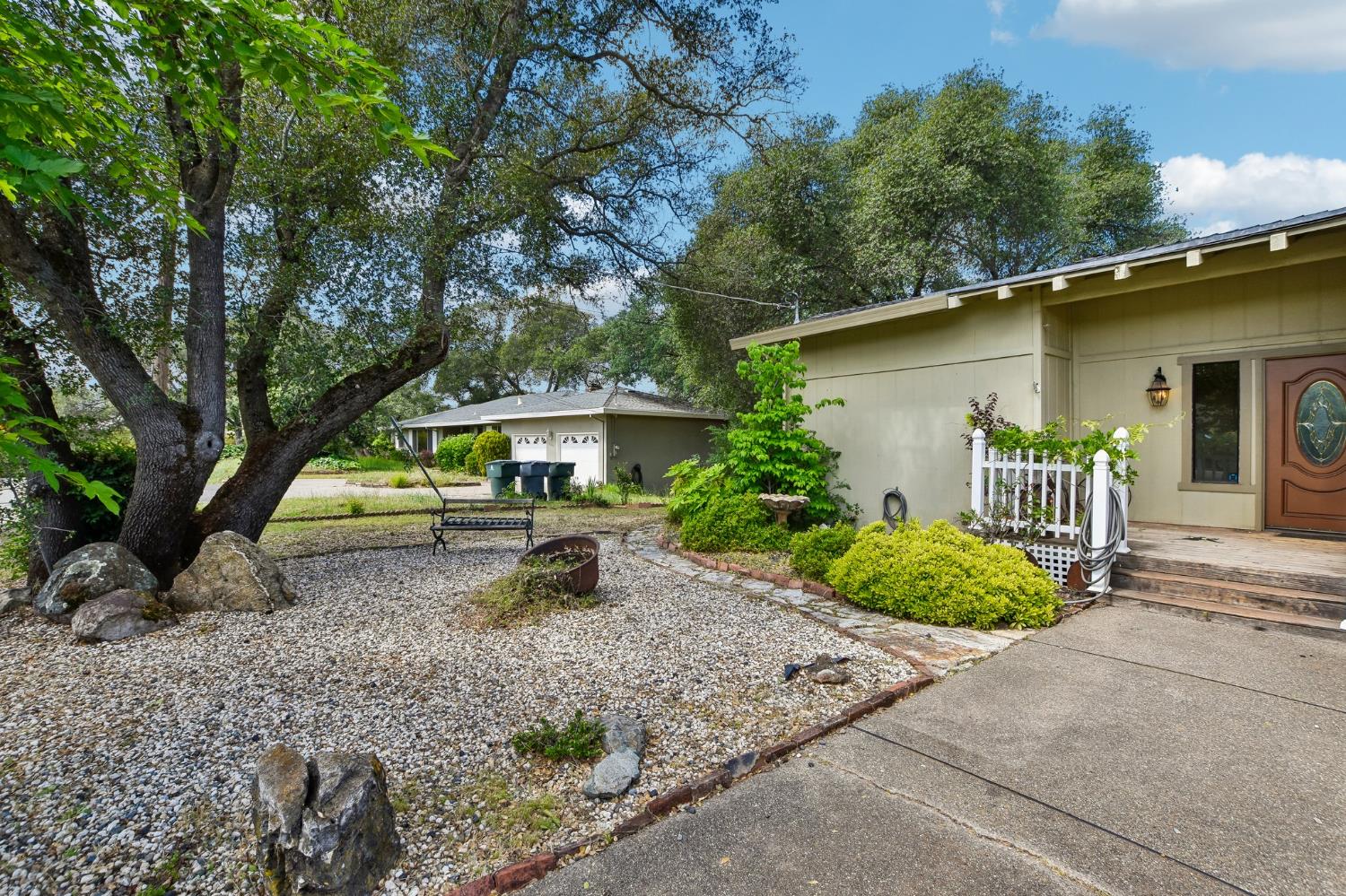 6180 Rustic Hills Drive Rocklin, CA 95677 - Photo 35 of 37 a backyard of a house with plants and outdoor seating