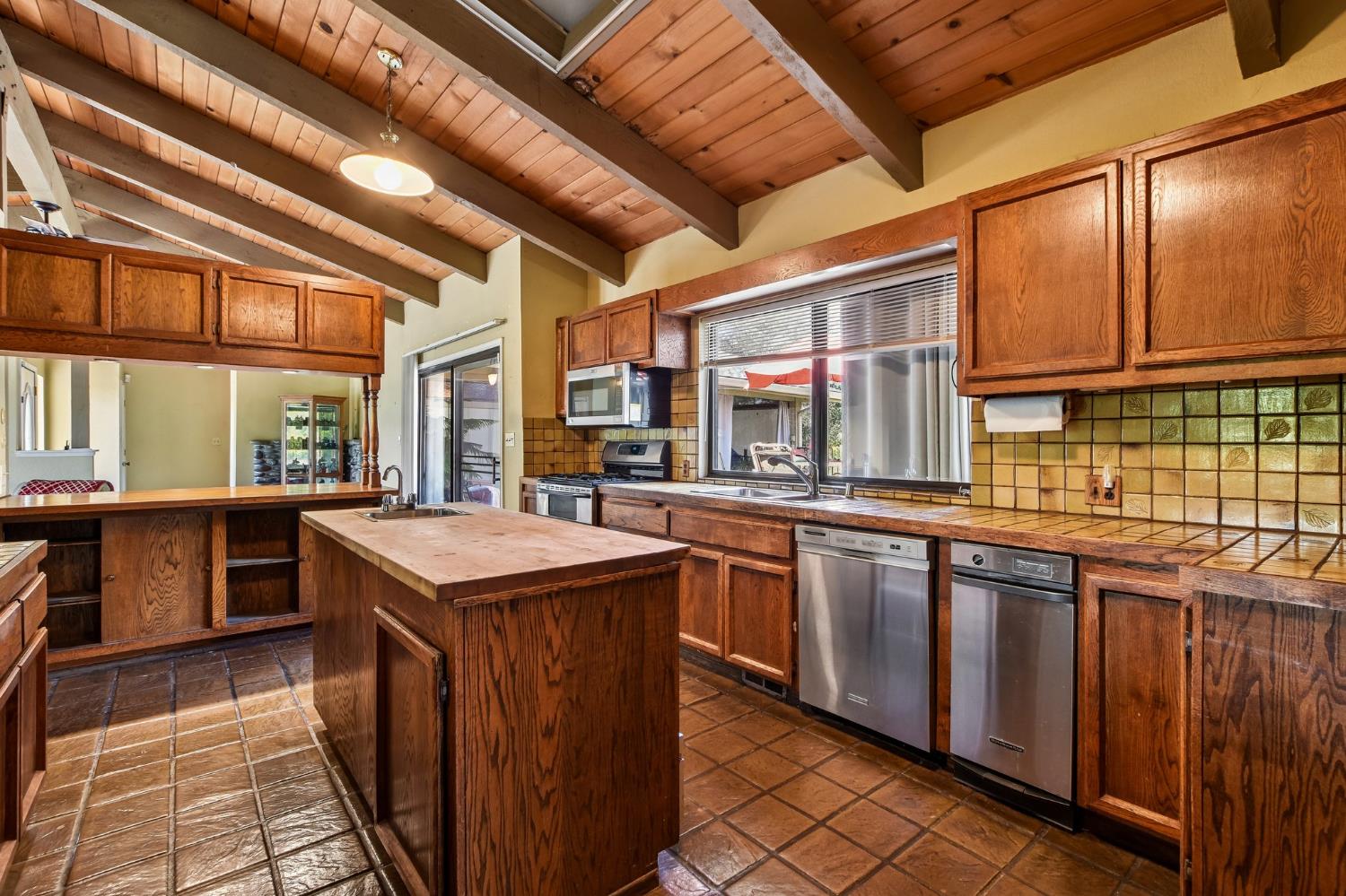 6180 Rustic Hills Drive Rocklin, CA 95677 - Photo 8 of 37 a kitchen with stainless steel appliances granite countertop a sink and wooden cabinets