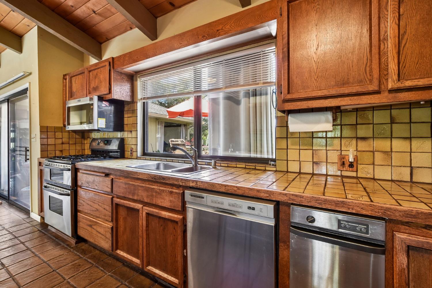 6180 Rustic Hills Drive Rocklin, CA 95677 - Photo 10 of 37 a kitchen with stainless steel appliances granite countertop a sink and a stove