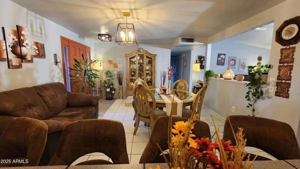 a living room with furniture flowerpot and window