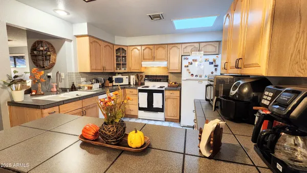 a kitchen with stainless steel appliances granite countertop a sink and cabinets