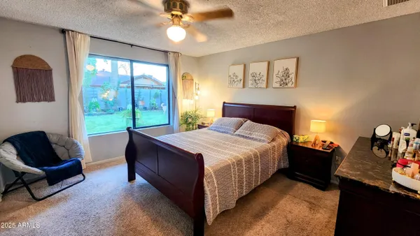 a bedroom with a bed and window