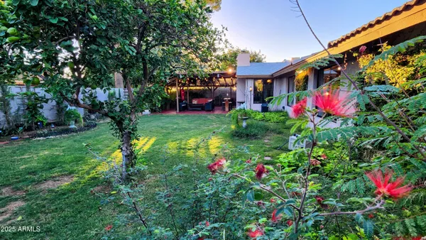 a view of a house with a yard and sitting area