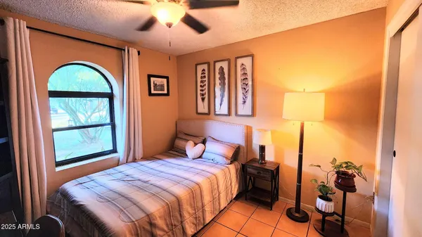 a bedroom with a large bed and a window