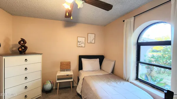 a bedroom with a bed and a window