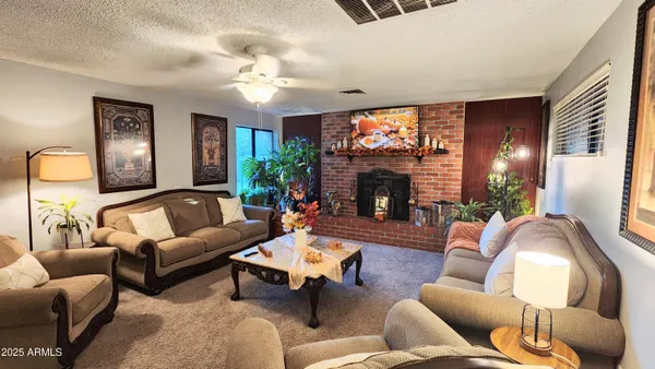 a living room with furniture a fireplace and a flat screen tv