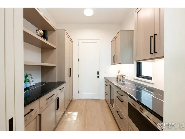 a kitchen with granite countertop a sink stove and cabinets