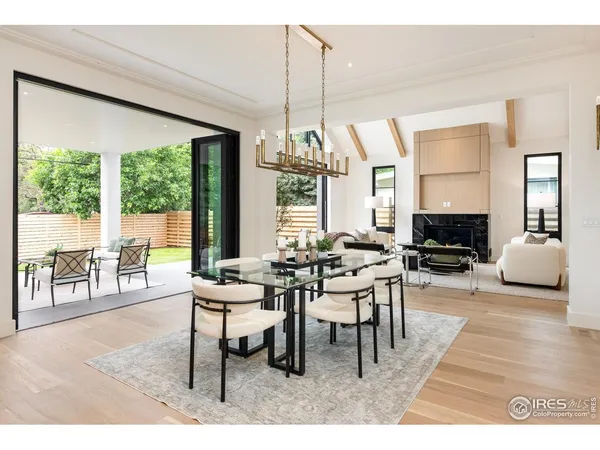 a dining room with furniture window and wooden floor