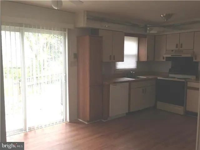 a kitchen with a sink cabinets and window