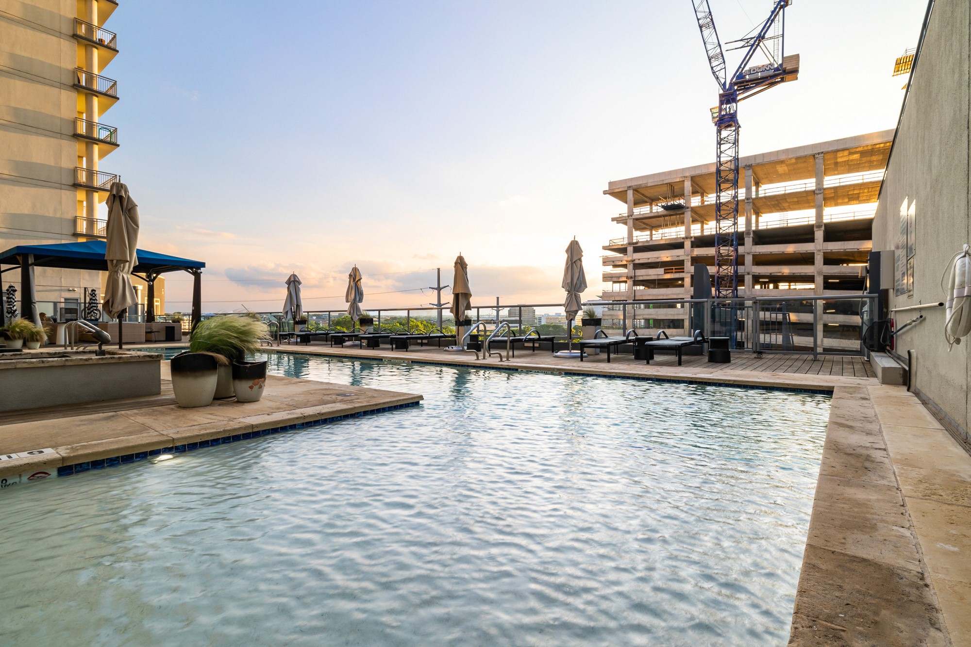 603 Davis Street, Unit 907 Austin, TX 78701 - Photo 20 of 22 Resort-style rooftop pool with plenty of lounge seating—an ideal spot to unwind just steps from Lady Bird Lake and the energy of the Rainey Street District.