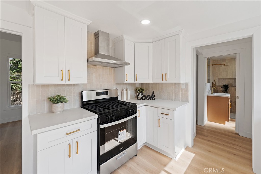 2158 Tenth Street Riverside, CA 92507 - Photo 14 of 24 a kitchen with stainless steel appliances granite countertop a sink a stove and cabinets