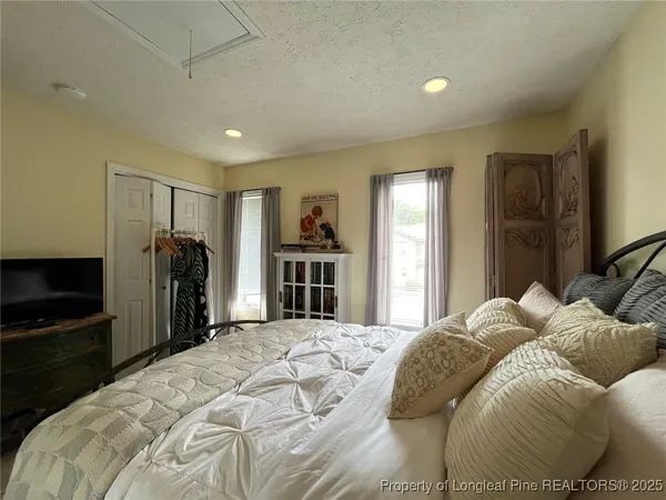 a bedroom with a large bed and a tv