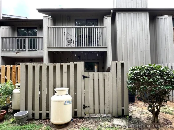a view of a house with a small yard and plants