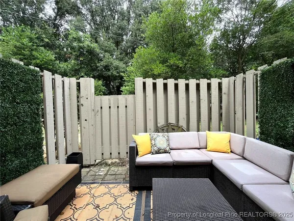 a building outdoor space with patio couch and a garden