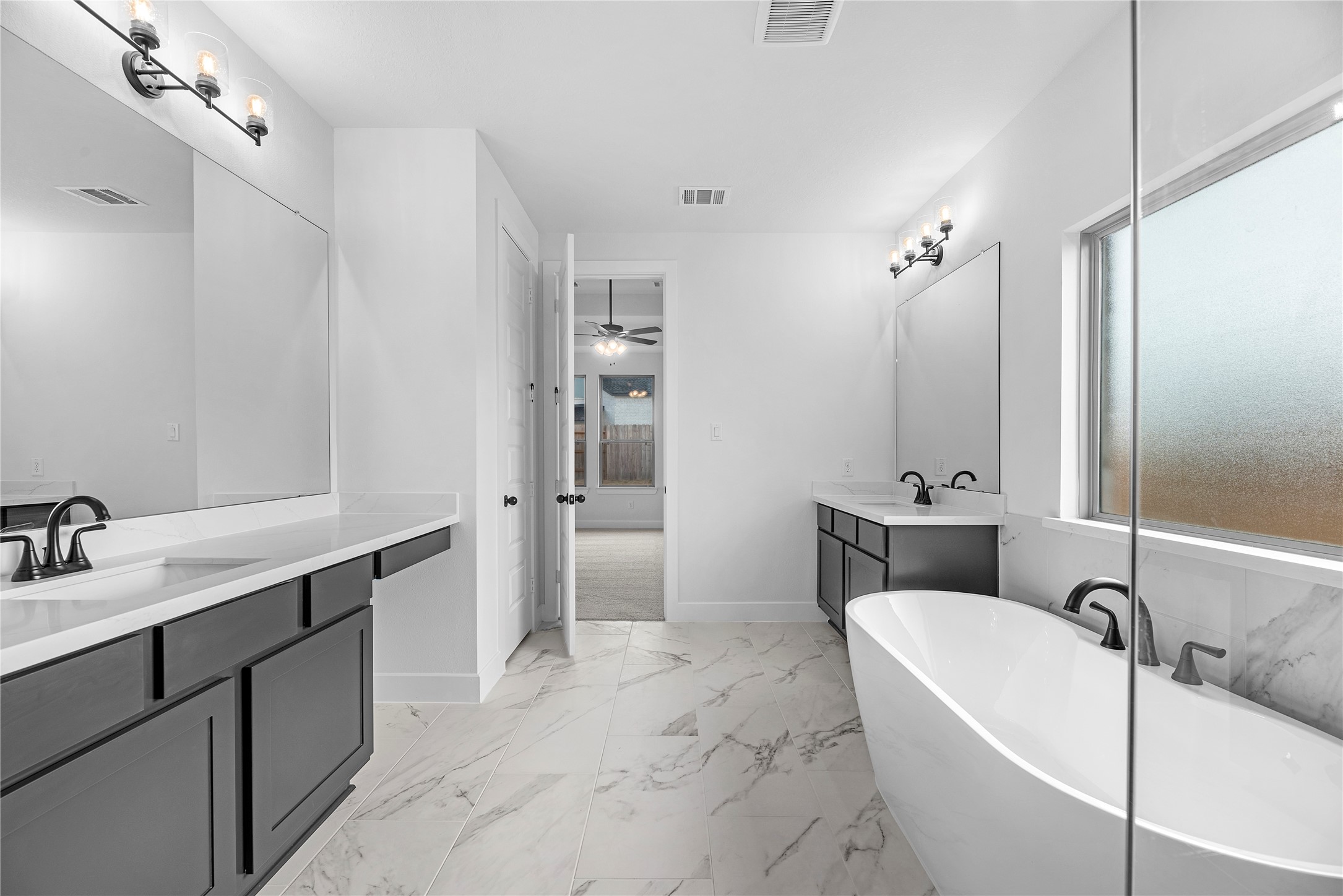 615 Roland Lane Rosenberg, TX 77471 - Photo 12 of 26 a bathroom with a tub sink toilet and mirror