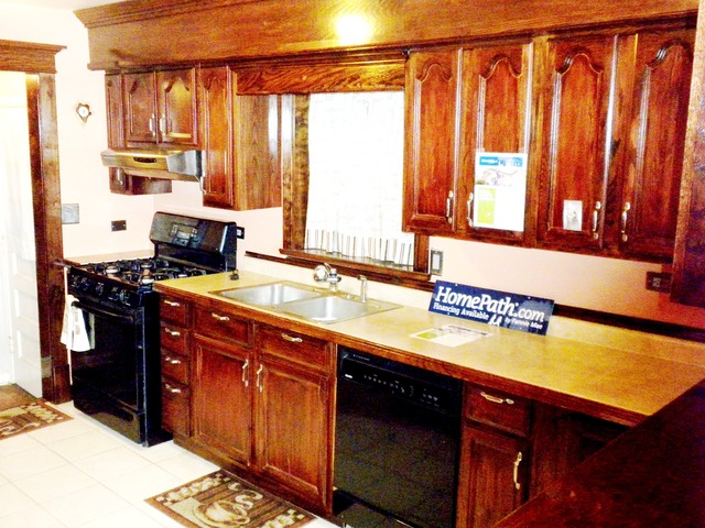 333 High Ridge Road Hillside, IL 60162 - Photo 2 of 21 a kitchen with stainless steel appliances granite countertop a sink a stove and a microwave