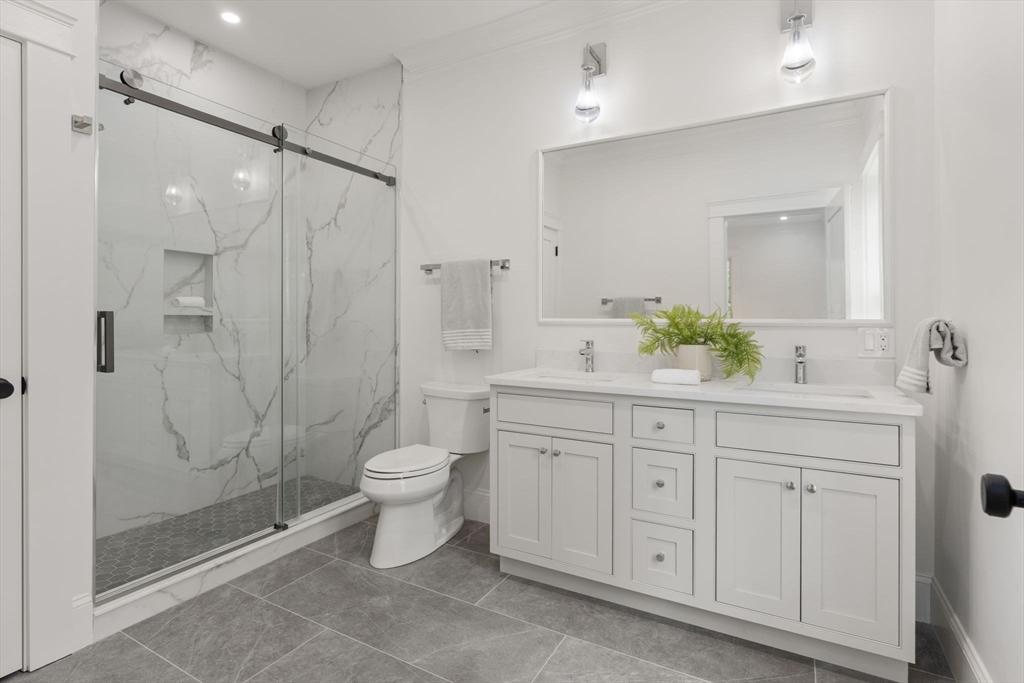 82 Deer Path Lane Weston, MA 02493 - Photo 24 of 42 a spacious bathroom with a double vanity sink toilet and shower