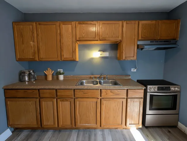 a kitchen with a sink a stove and cabinets
