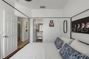 a bedroom with furniture and wall paintings