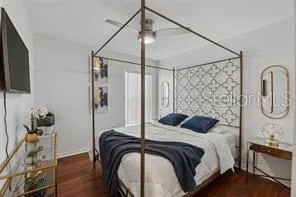 a bedroom with a bed and a chandelier