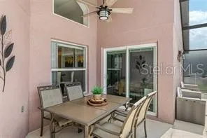 a view of a dining room with furniture and a floor to ceiling window